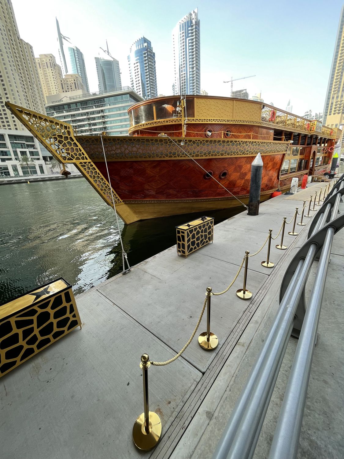 Ornate gold and wood luxury dhow at the marina